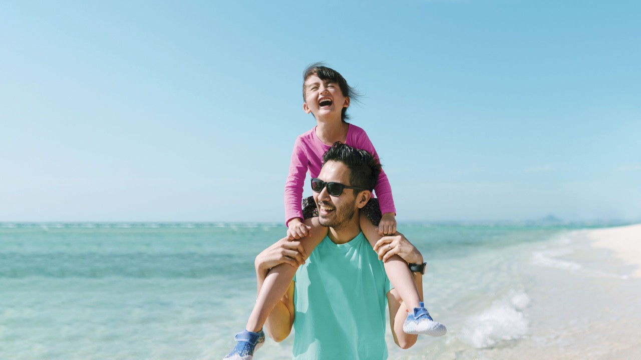 A girl enjoying piggyback ride on father.; image used for HSBC Savings Protector Plan Insurance.