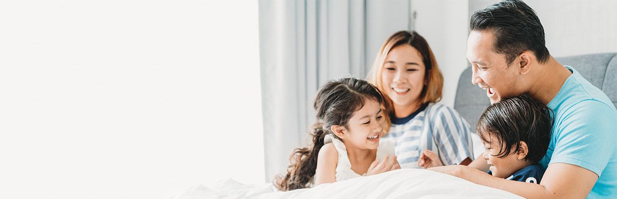 Families are laughing and having fun on the sofa; images used for HSBC investment. 