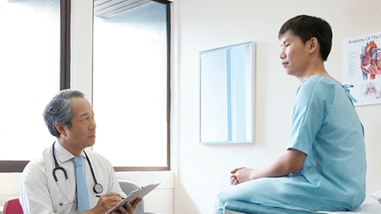 A doctor is discussing medical record with patient; image used for HSBC Early Critical Care.