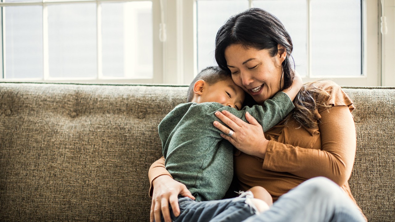 A son is hugging with his mother; image used for HSBC Mortgage Protector Insurance.
