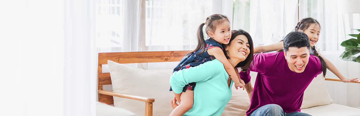 Parents playing with daughter at home; image used for HSBC Life Online Endowment.